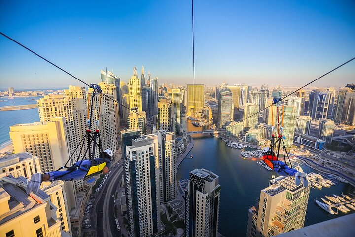 Soar over the stunning skyline of Dubai Marina taking in breathtaking views while gliding at 80 km/h for an unforgettable experience that showcases the city's beauty from above.